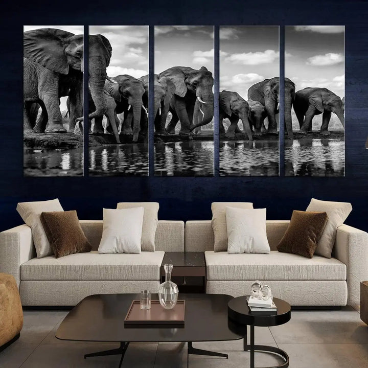 A stunning "Wall Art Animal Canvas Print" featuring a black and white photo of a herd of elephants drinking water is elegantly displayed, gallery wrapped on museum-quality canvas.