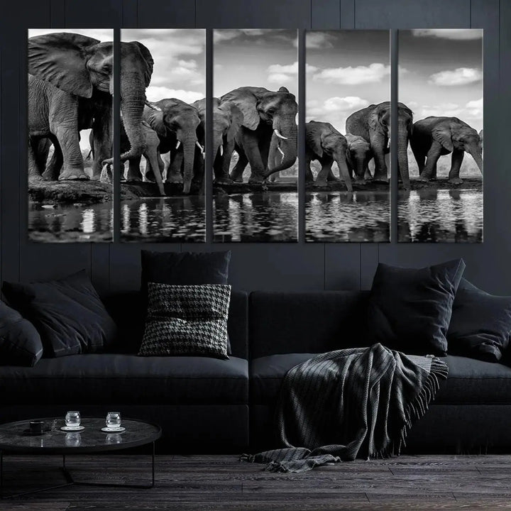 A stunning "Wall Art Animal Canvas Print" featuring a black and white photo of a herd of elephants drinking water is elegantly displayed, gallery wrapped on museum-quality canvas.