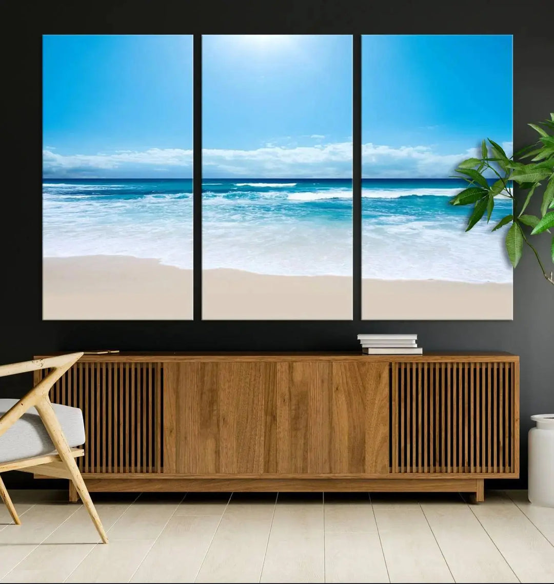 A triptych wall art canvas print titled "Shiny Blue Sea and Beach," crafted on museum-quality canvas, depicts a serene beach scene.