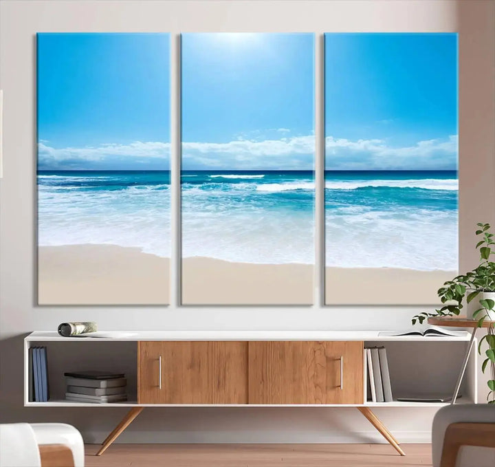 A triptych wall art canvas print titled "Shiny Blue Sea and Beach," crafted on museum-quality canvas, depicts a serene beach scene.