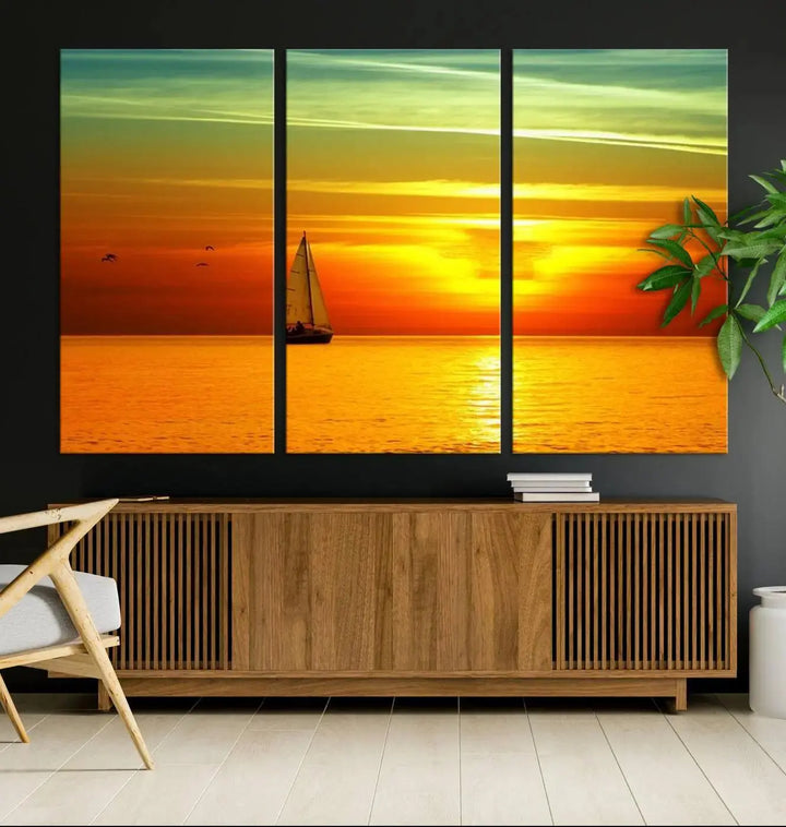 The "Wall Art Canvas Sailboat and Sailors at Sunset" is a triptych showcasing a vibrant sunset over the sea with a sailboat, elegantly displayed on gallery-wrapped, museum-quality canvas. The artworks feature a UV-protective coating to ensure their radiant colors are preserved for years to come.