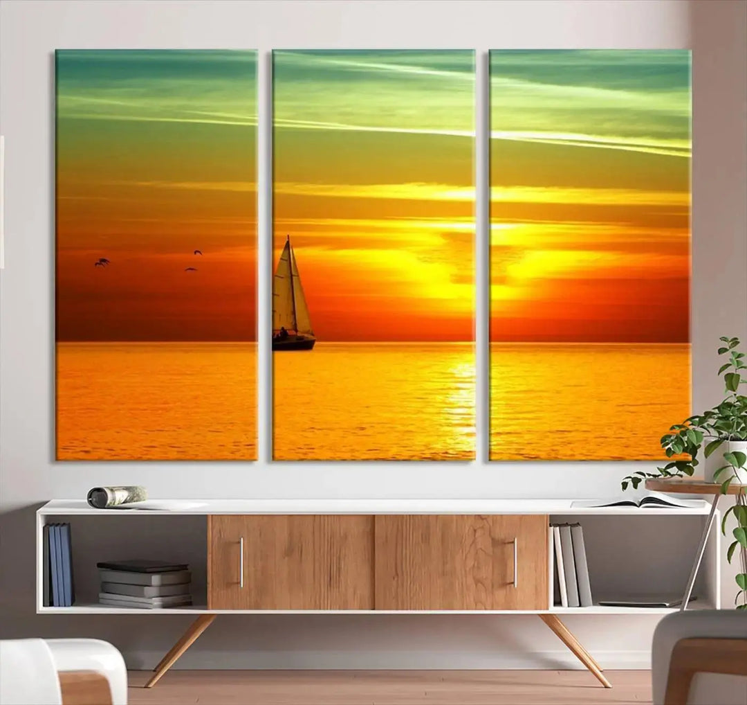 The "Wall Art Canvas Sailboat and Sailors at Sunset" is a triptych showcasing a vibrant sunset over the sea with a sailboat, elegantly displayed on gallery-wrapped, museum-quality canvas. The artworks feature a UV-protective coating to ensure their radiant colors are preserved for years to come.