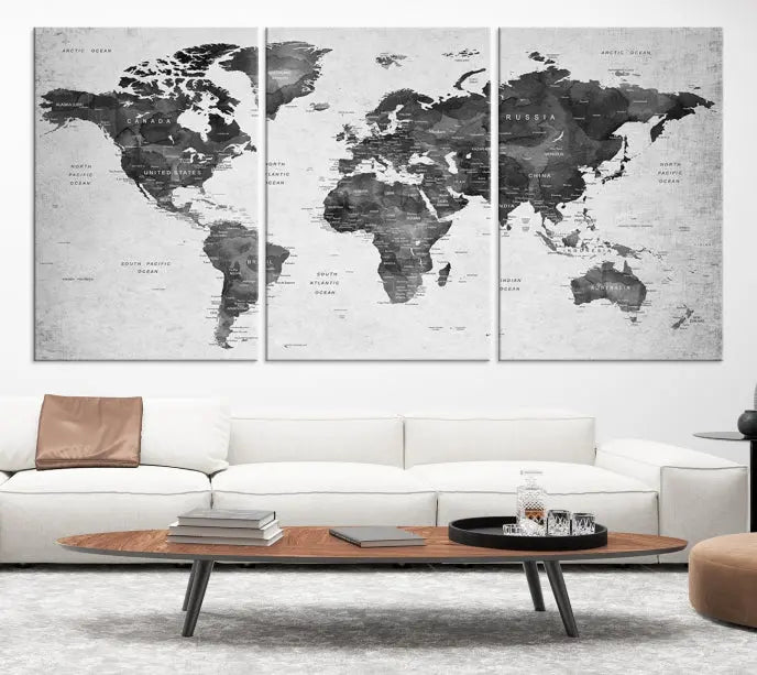 The "Wall Art Gray Black World Map Print" triptych, elegantly gallery wrapped on museum-quality canvas, adorns the wall.