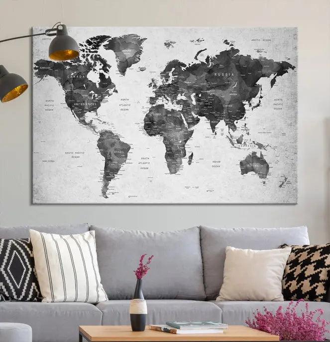 The "Wall Art Gray Black World Map Print" triptych, elegantly gallery wrapped on museum-quality canvas, adorns the wall.