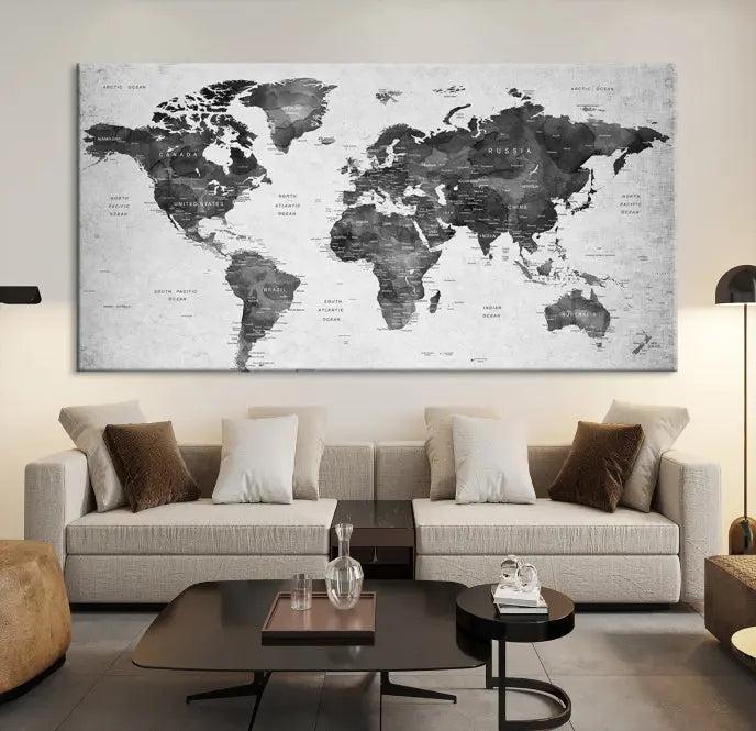 The "Wall Art Gray Black World Map Print" triptych, elegantly gallery wrapped on museum-quality canvas, adorns the wall.