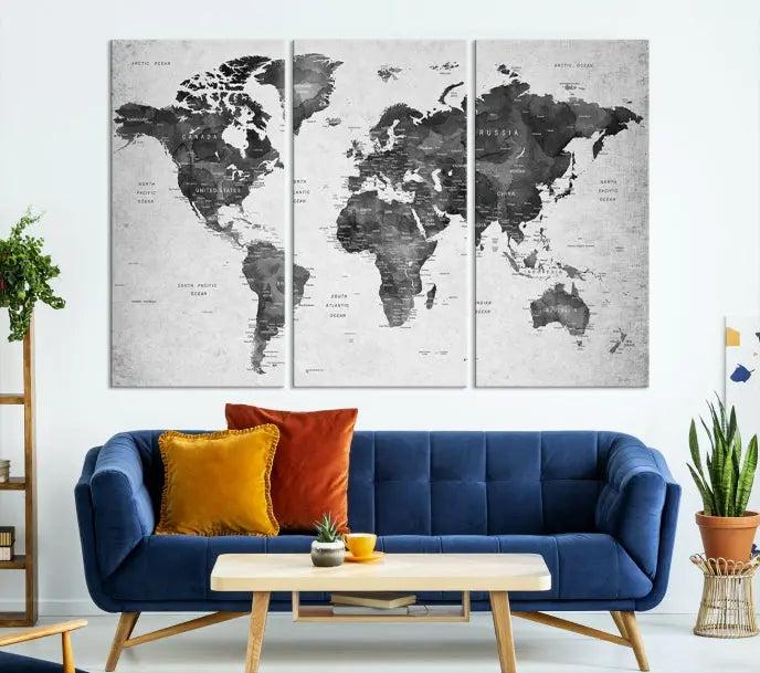 The "Wall Art Gray Black World Map Print" triptych, elegantly gallery wrapped on museum-quality canvas, adorns the wall.