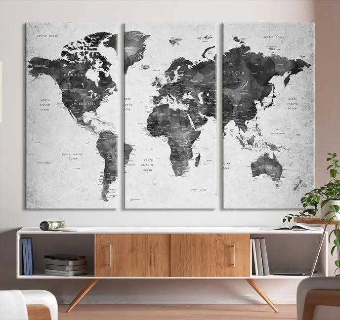 The "Wall Art Gray Black World Map Print" triptych, elegantly gallery wrapped on museum-quality canvas, adorns the wall.