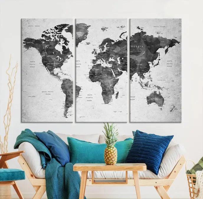 The "Wall Art Gray Black World Map Print" triptych, elegantly gallery wrapped on museum-quality canvas, adorns the wall.