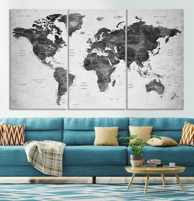 The "Wall Art Gray Black World Map Print" triptych, elegantly gallery wrapped on museum-quality canvas, adorns the wall.