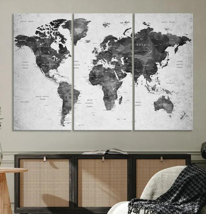 The "Wall Art Gray Black World Map Print" triptych, elegantly gallery wrapped on museum-quality canvas, adorns the wall.