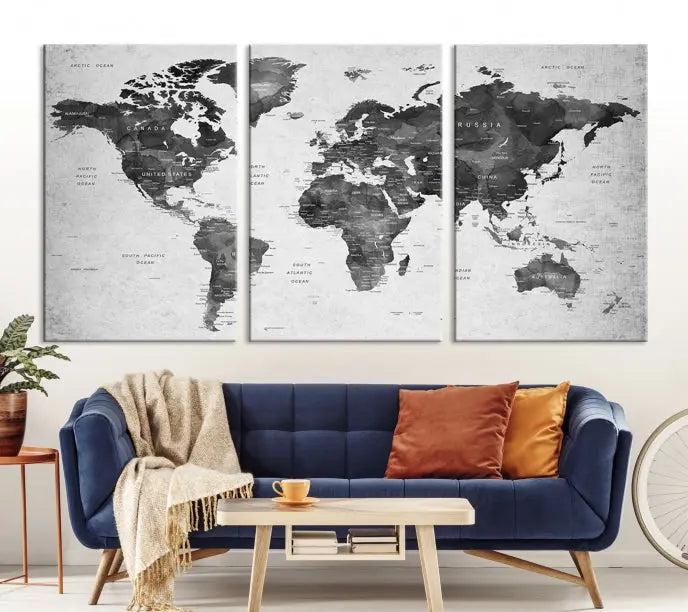 The "Wall Art Gray Black World Map Print" triptych, elegantly gallery wrapped on museum-quality canvas, adorns the wall.