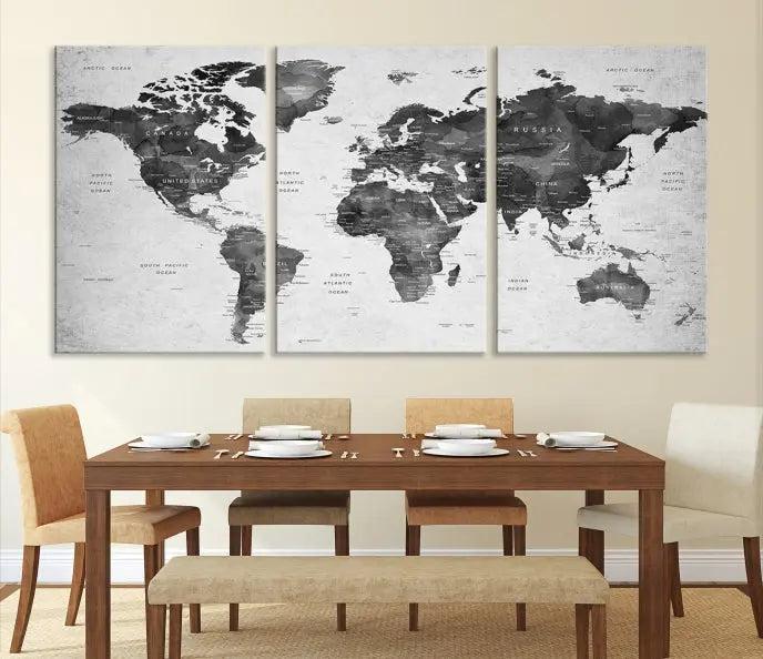 The "Wall Art Gray Black World Map Print" triptych, elegantly gallery wrapped on museum-quality canvas, adorns the wall.