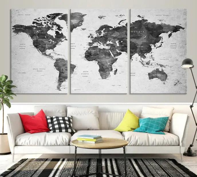 The "Wall Art Gray Black World Map Print" triptych, elegantly gallery wrapped on museum-quality canvas, adorns the wall.