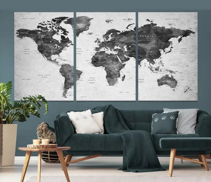 The "Wall Art Gray Black World Map Print" triptych, elegantly gallery wrapped on museum-quality canvas, adorns the wall.