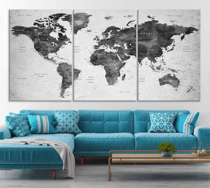 The "Wall Art Gray Black World Map Print" triptych, elegantly gallery wrapped on museum-quality canvas, adorns the wall.