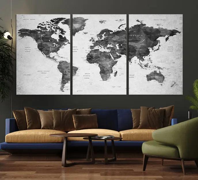 The "Wall Art Gray Black World Map Print" triptych, elegantly gallery wrapped on museum-quality canvas, adorns the wall.