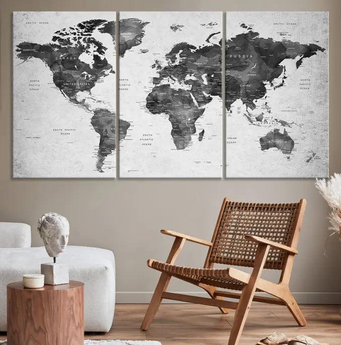 The "Wall Art Gray Black World Map Print" triptych, elegantly gallery wrapped on museum-quality canvas, adorns the wall.