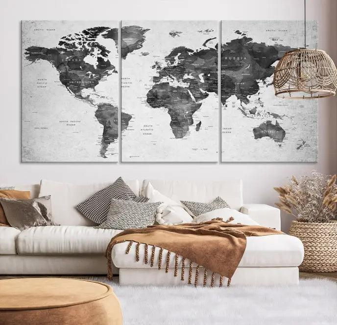 The "Wall Art Gray Black World Map Print" triptych, elegantly gallery wrapped on museum-quality canvas, adorns the wall.