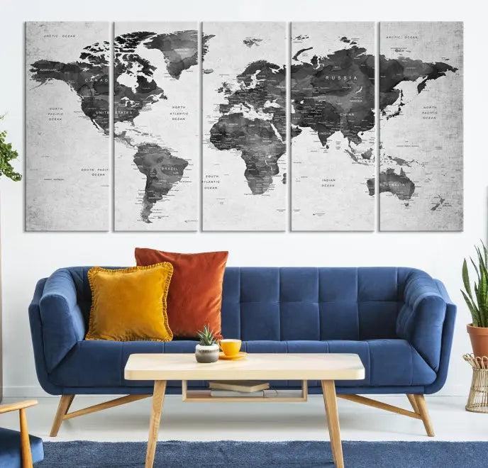 The "Wall Art Gray Black World Map Print" triptych, elegantly gallery wrapped on museum-quality canvas, adorns the wall.