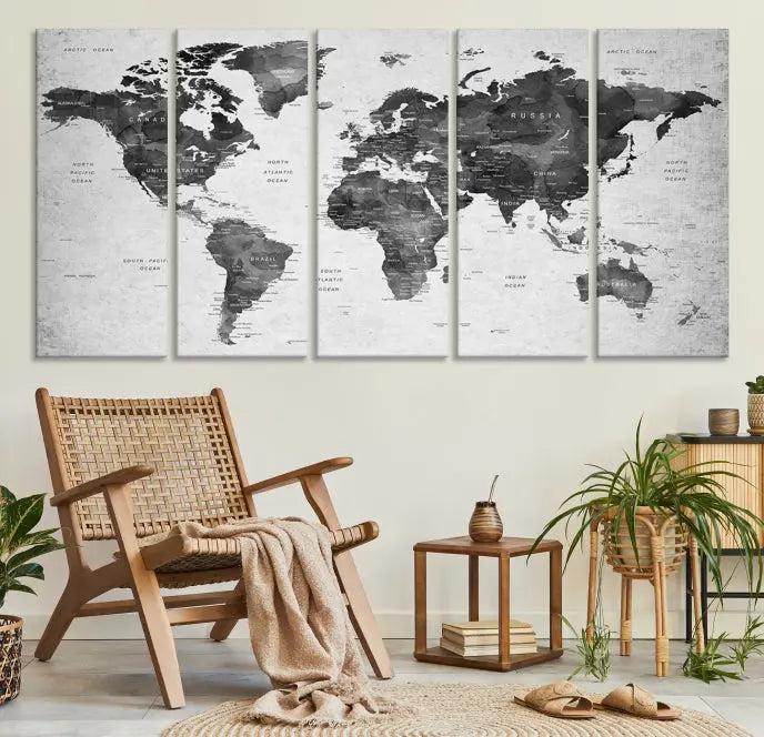 The "Wall Art Gray Black World Map Print" triptych, elegantly gallery wrapped on museum-quality canvas, adorns the wall.