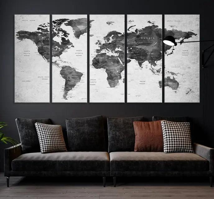 The "Wall Art Gray Black World Map Print" triptych, elegantly gallery wrapped on museum-quality canvas, adorns the wall.