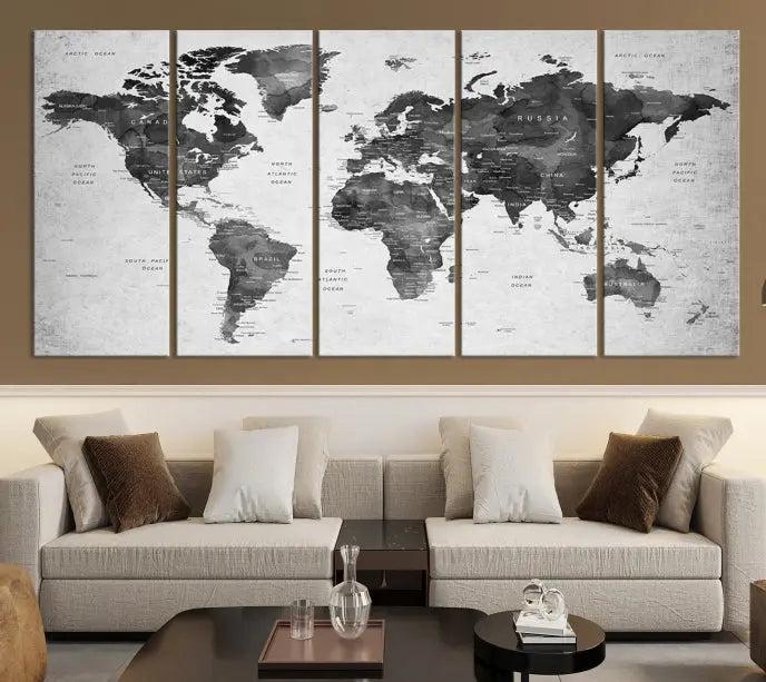 The "Wall Art Gray Black World Map Print" triptych, elegantly gallery wrapped on museum-quality canvas, adorns the wall.