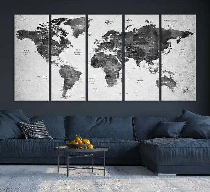 The "Wall Art Gray Black World Map Print" triptych, elegantly gallery wrapped on museum-quality canvas, adorns the wall.