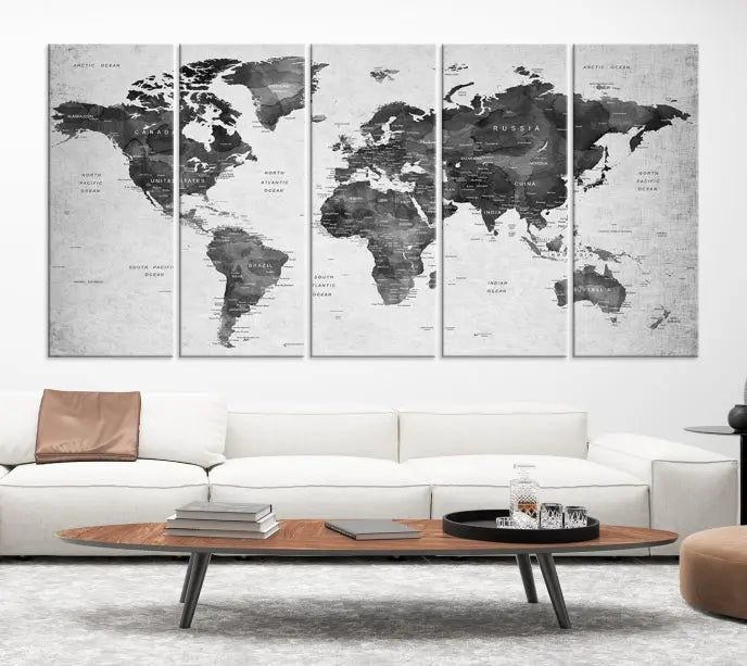 The "Wall Art Gray Black World Map Print" triptych, elegantly gallery wrapped on museum-quality canvas, adorns the wall.