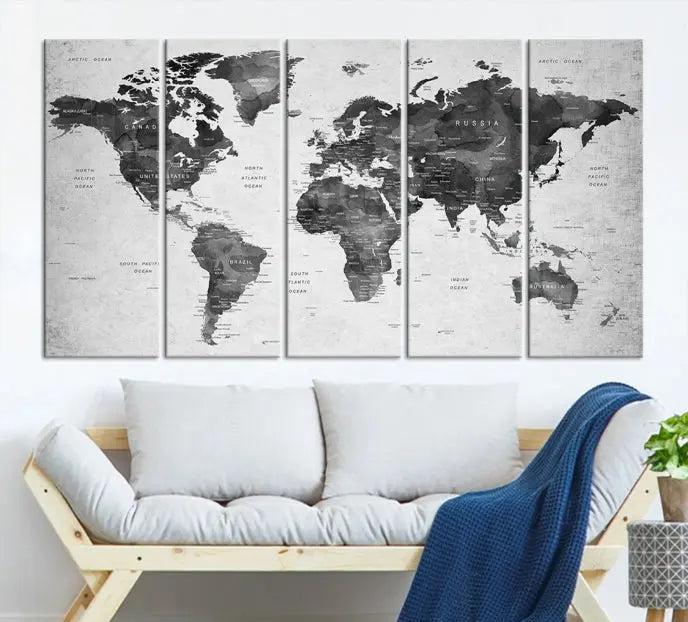 The "Wall Art Gray Black World Map Print" triptych, elegantly gallery wrapped on museum-quality canvas, adorns the wall.