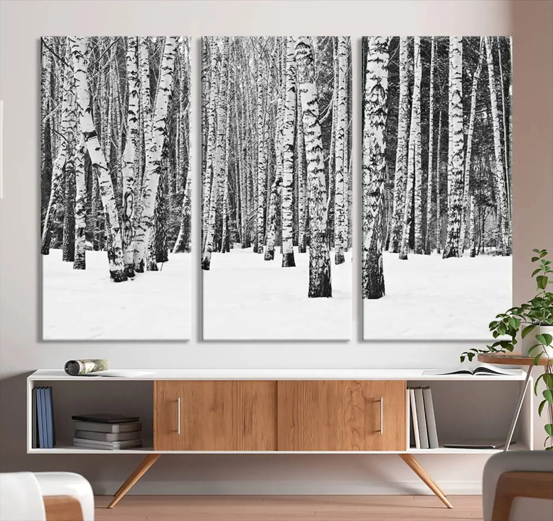 A canvas print titled "Wall Art Landscape Canvas Print Forest in Winter with Snowy Ground and Trees" is displayed, enhancing the modern living room's decor.