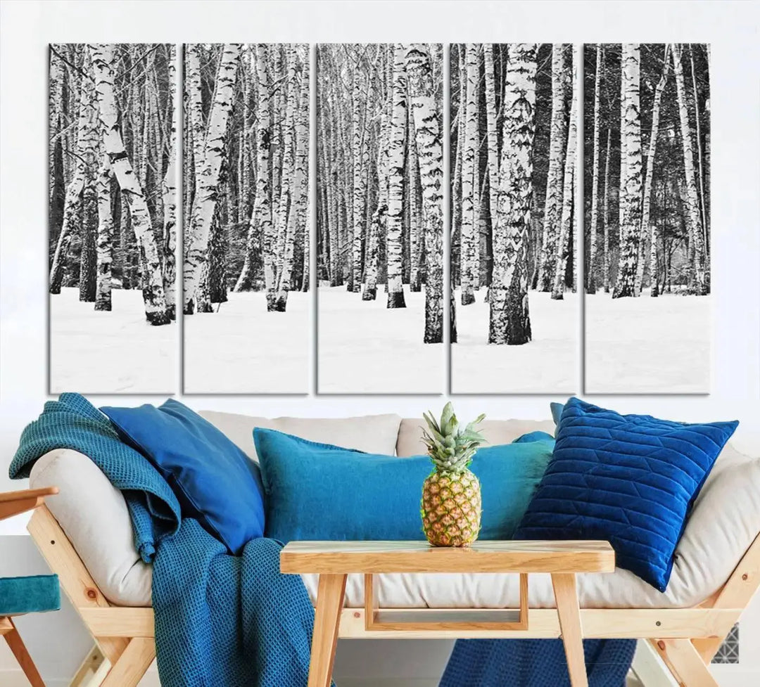 A canvas print titled "Wall Art Landscape Canvas Print Forest in Winter with Snowy Ground and Trees" is displayed, enhancing the modern living room's decor.