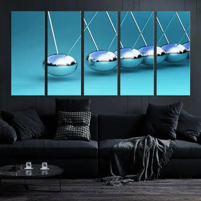 The Wall Art Newton's Cradle Canvas Print is displayed as a triptych on a teal background. Each piece is gallery-wrapped and crafted on museum-quality canvases with a UV-protective coating, ensuring lasting vibrancy and protection.