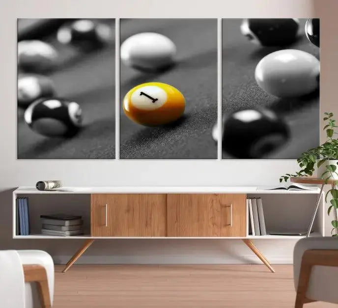 The Wall Art Pool Table and Balls Canvas Print features a triptych design with vibrant billiard balls, highlighting the yellow number 1 ball. This captivating piece is handmade in the USA on museum-quality canvas, offering an exquisite enhancement to your space. It comes with free shipping for your convenience.