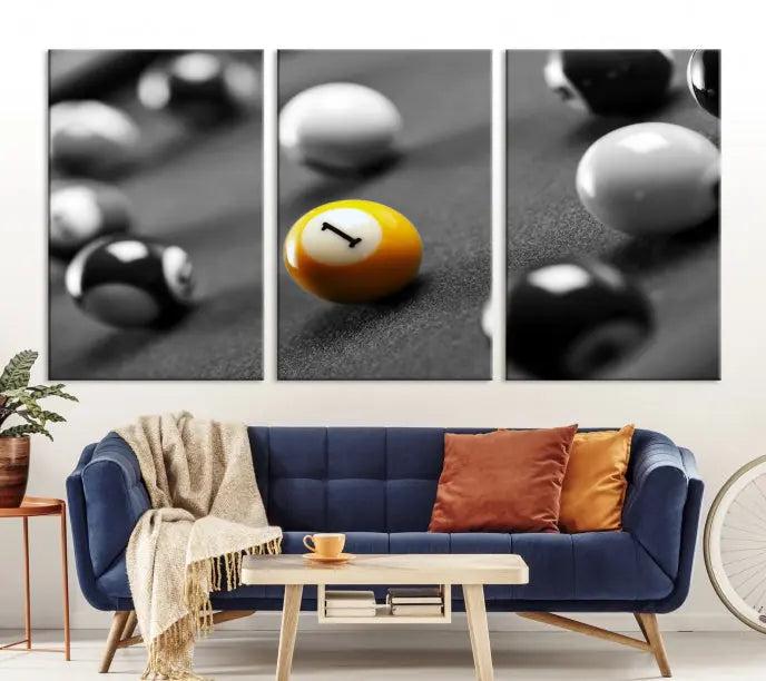 The Wall Art Pool Table and Balls Canvas Print features a triptych design with vibrant billiard balls, highlighting the yellow number 1 ball. This captivating piece is handmade in the USA on museum-quality canvas, offering an exquisite enhancement to your space. It comes with free shipping for your convenience.