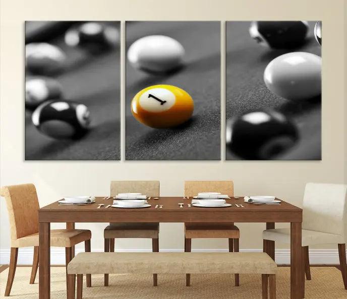 The Wall Art Pool Table and Balls Canvas Print features a triptych design with vibrant billiard balls, highlighting the yellow number 1 ball. This captivating piece is handmade in the USA on museum-quality canvas, offering an exquisite enhancement to your space. It comes with free shipping for your convenience.