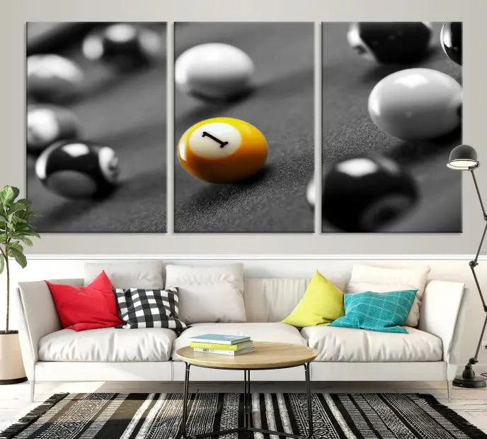 The Wall Art Pool Table and Balls Canvas Print features a triptych design with vibrant billiard balls, highlighting the yellow number 1 ball. This captivating piece is handmade in the USA on museum-quality canvas, offering an exquisite enhancement to your space. It comes with free shipping for your convenience.