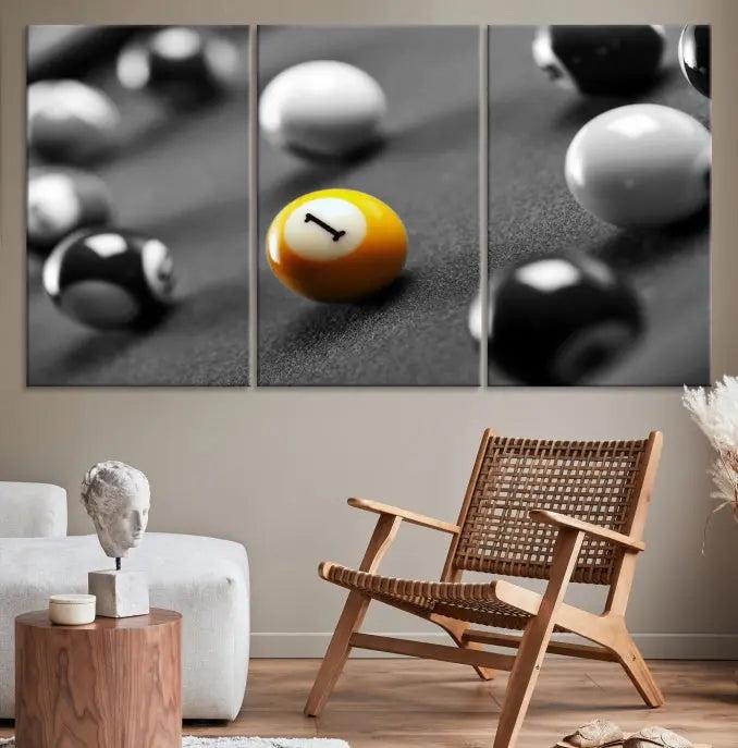 The Wall Art Pool Table and Balls Canvas Print features a triptych design with vibrant billiard balls, highlighting the yellow number 1 ball. This captivating piece is handmade in the USA on museum-quality canvas, offering an exquisite enhancement to your space. It comes with free shipping for your convenience.