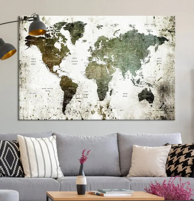 A Wall Art Push Pin World Map Canvas Print is displayed, showcasing an abstract world map in earthy tones. This museum-quality canvas is ready to hang and includes a UV-protective coating to maintain its vibrant shades.