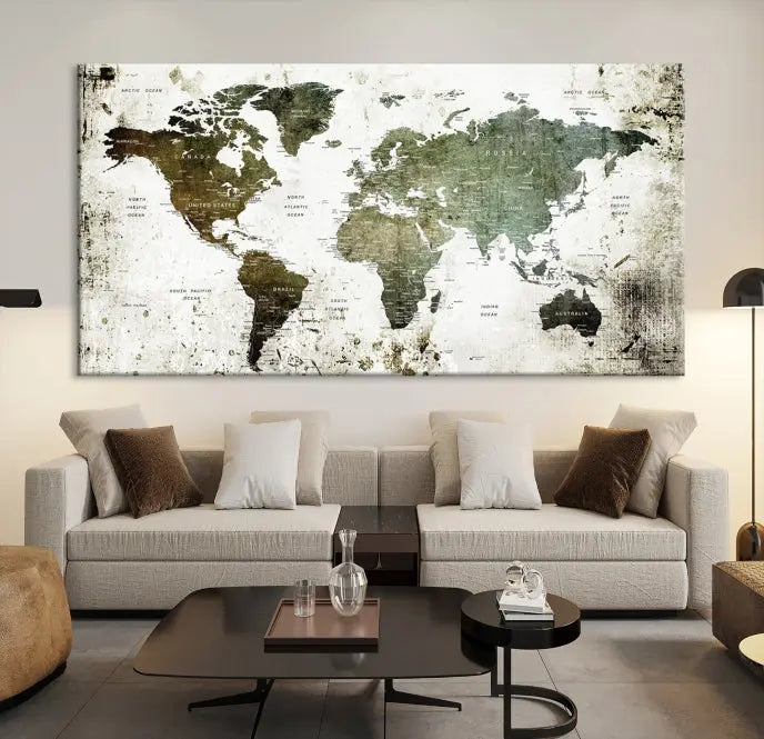 A Wall Art Push Pin World Map Canvas Print is displayed, showcasing an abstract world map in earthy tones. This museum-quality canvas is ready to hang and includes a UV-protective coating to maintain its vibrant shades.