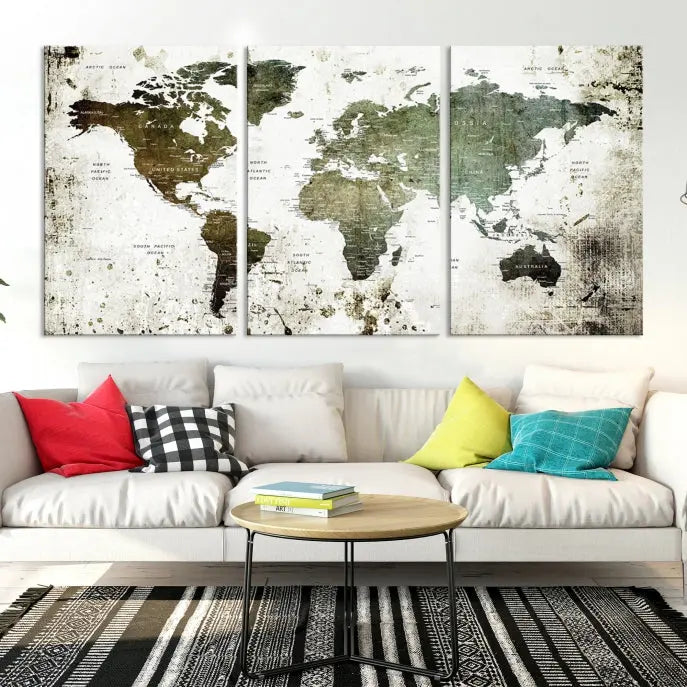 A Wall Art Push Pin World Map Canvas Print is displayed, showcasing an abstract world map in earthy tones. This museum-quality canvas is ready to hang and includes a UV-protective coating to maintain its vibrant shades.