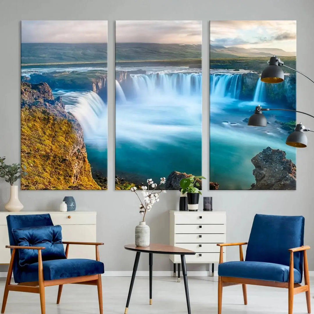 A large triptych of the "Wall Art Waterfall Canvas Print Grand Waterfall on a Plain" adorns the living room wall, crafted on museum-quality canvas. This artwork—handmade in the USA—comes with free shipping for those wishing to elevate their space.