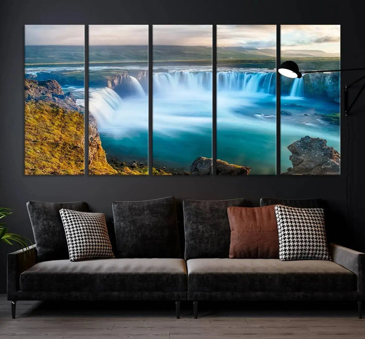 A large triptych of the "Wall Art Waterfall Canvas Print Grand Waterfall on a Plain" adorns the living room wall, crafted on museum-quality canvas. This artwork—handmade in the USA—comes with free shipping for those wishing to elevate their space.