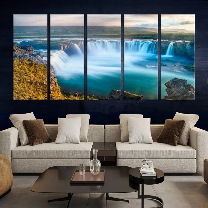 A large triptych of the "Wall Art Waterfall Canvas Print Grand Waterfall on a Plain" adorns the living room wall, crafted on museum-quality canvas. This artwork—handmade in the USA—comes with free shipping for those wishing to elevate their space.