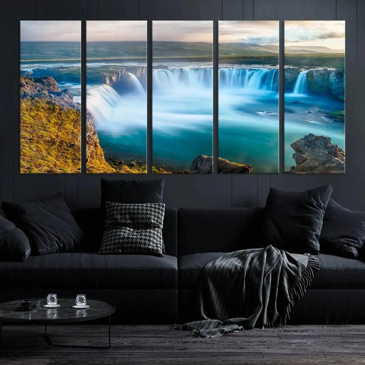 A large triptych of the "Wall Art Waterfall Canvas Print Grand Waterfall on a Plain" adorns the living room wall, crafted on museum-quality canvas. This artwork—handmade in the USA—comes with free shipping for those wishing to elevate their space.