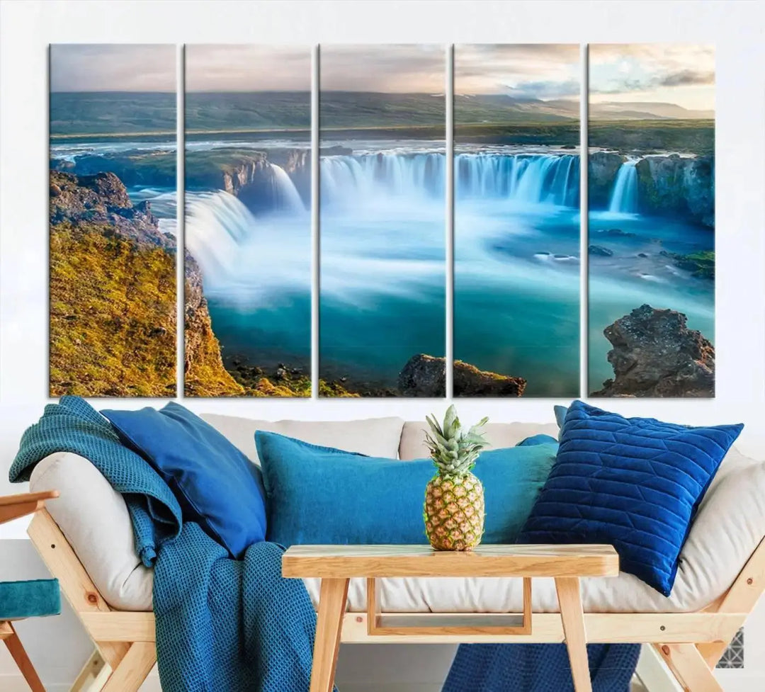 A large triptych of the "Wall Art Waterfall Canvas Print Grand Waterfall on a Plain" adorns the living room wall, crafted on museum-quality canvas. This artwork—handmade in the USA—comes with free shipping for those wishing to elevate their space.