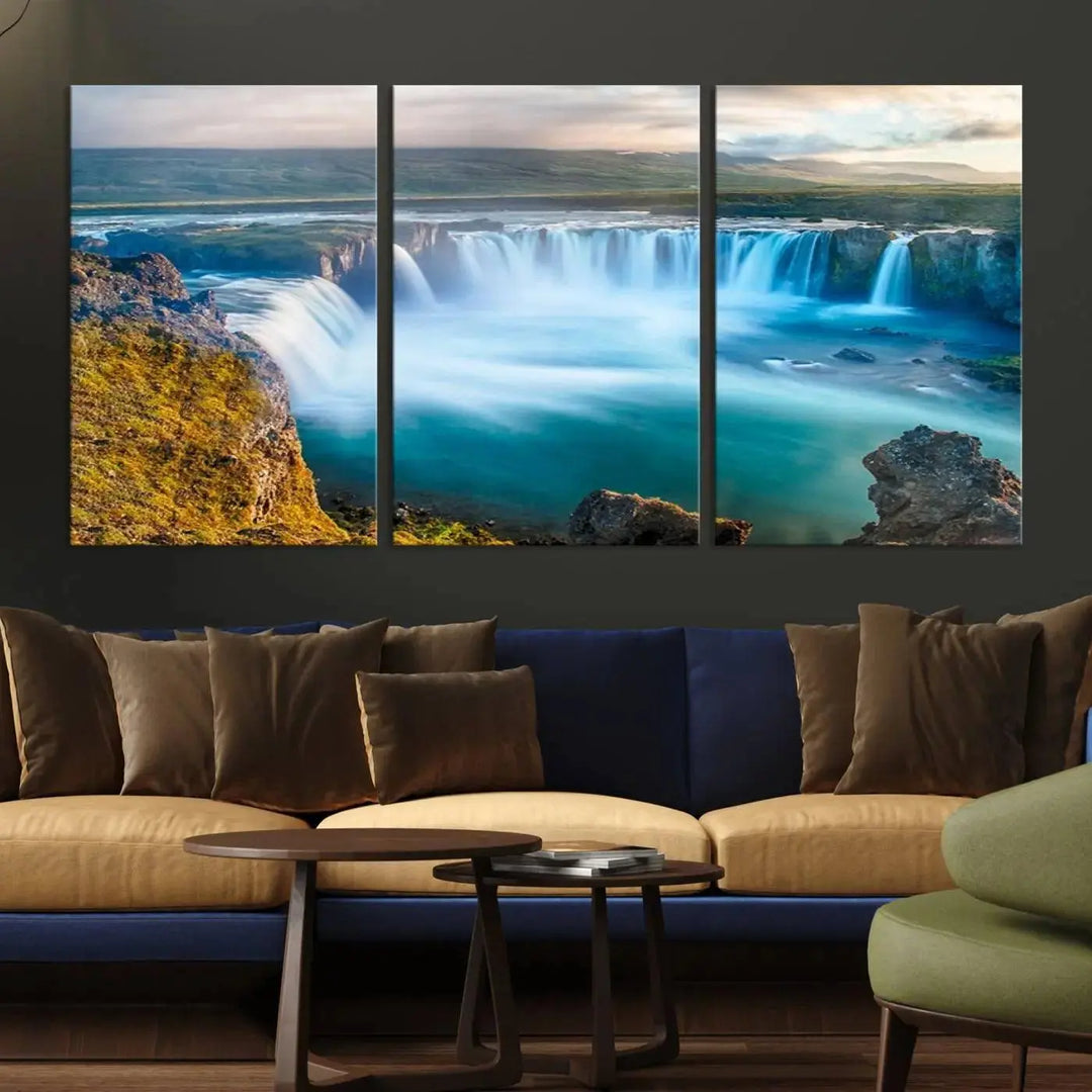 A large triptych of the "Wall Art Waterfall Canvas Print Grand Waterfall on a Plain" adorns the living room wall, crafted on museum-quality canvas. This artwork—handmade in the USA—comes with free shipping for those wishing to elevate their space.