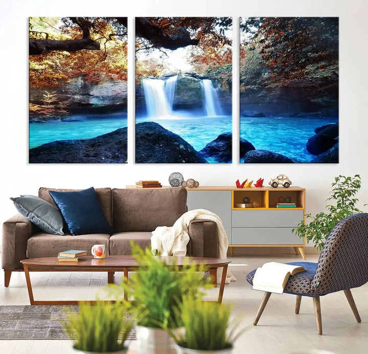 In the living room, a hand-assembled triptych titled "Wall Art Waterfall Canvas Print Great Double Waterfalls with Bright Water in Forest" is displayed on museum-quality canvas.