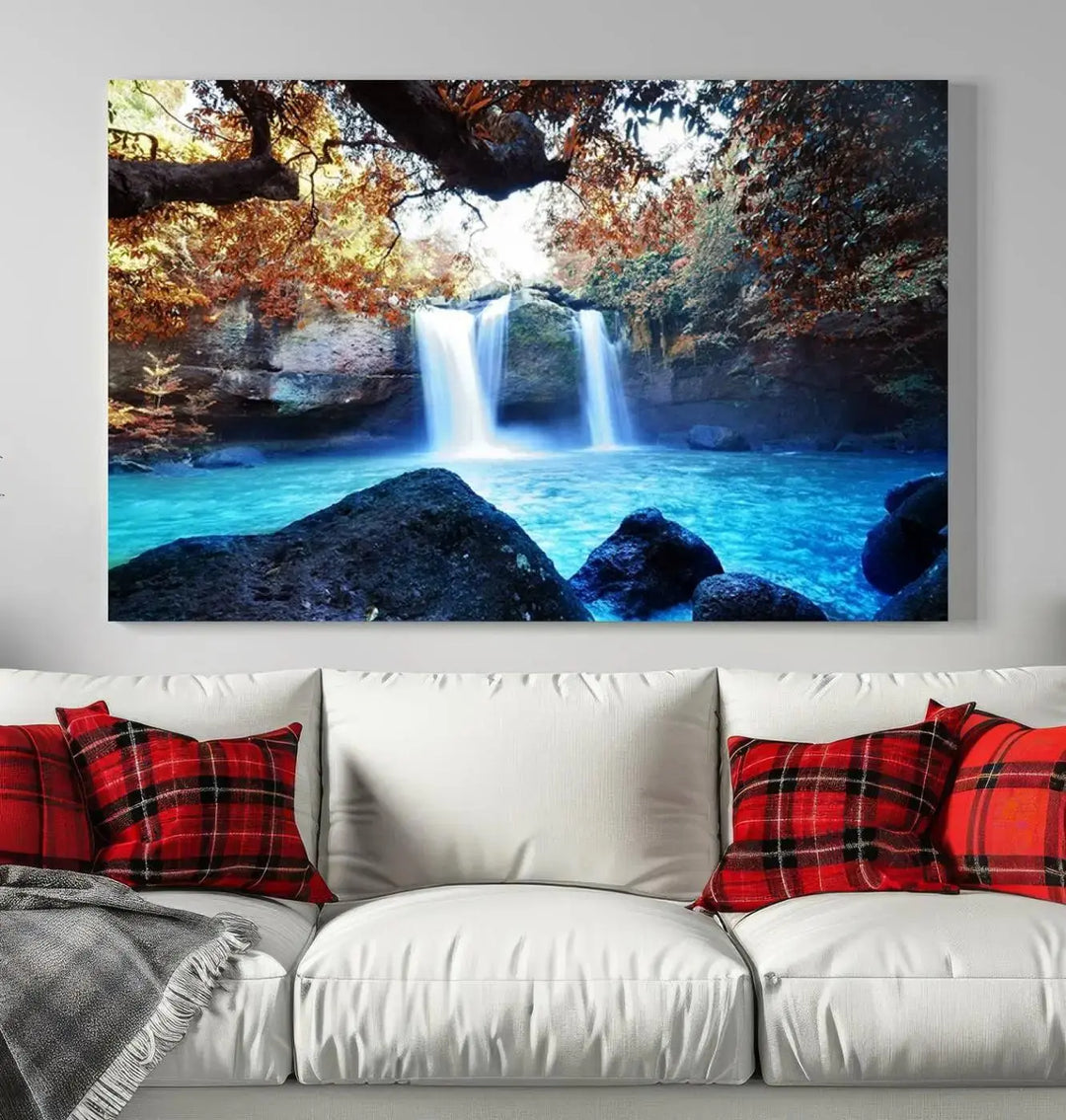 In the living room, a hand-assembled triptych titled "Wall Art Waterfall Canvas Print Great Double Waterfalls with Bright Water in Forest" is displayed on museum-quality canvas.