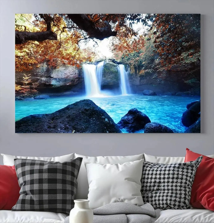 In the living room, a hand-assembled triptych titled "Wall Art Waterfall Canvas Print Great Double Waterfalls with Bright Water in Forest" is displayed on museum-quality canvas.