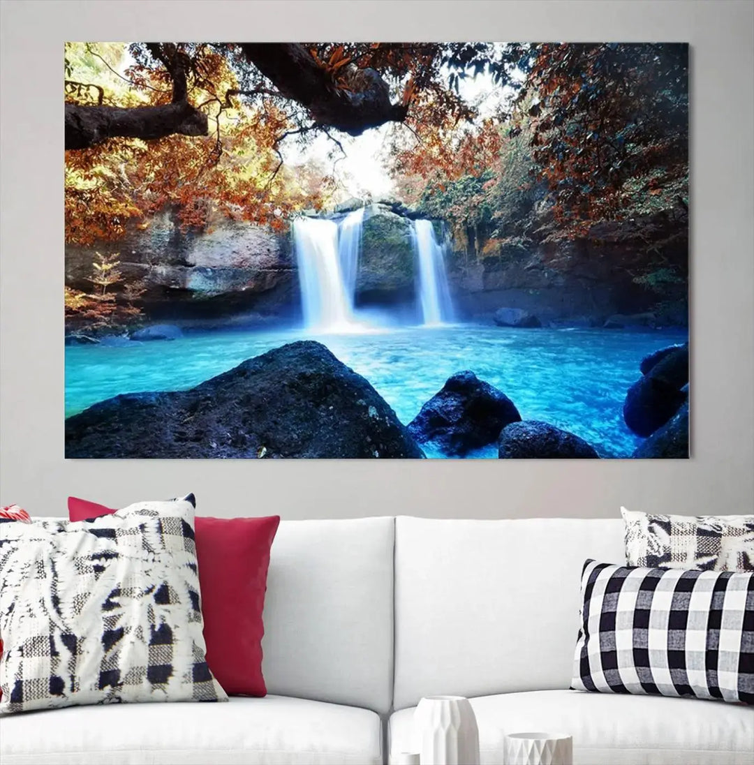 In the living room, a hand-assembled triptych titled "Wall Art Waterfall Canvas Print Great Double Waterfalls with Bright Water in Forest" is displayed on museum-quality canvas.